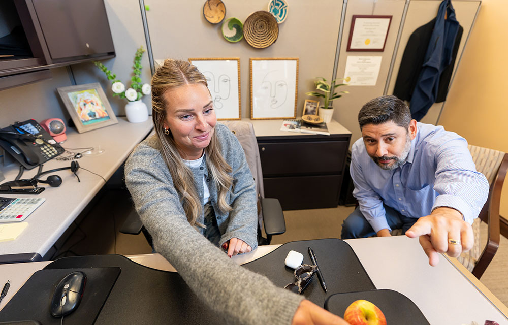 Two people looking at a computer screen