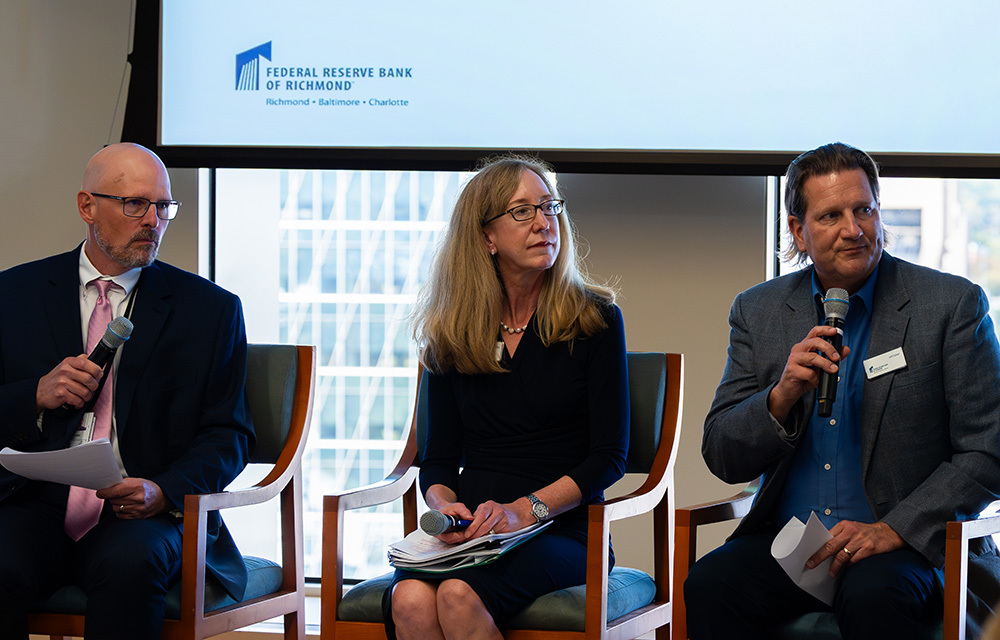 Three panelists with microphones