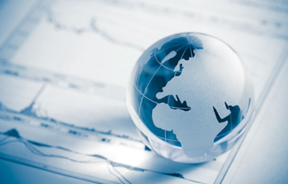 Glass globe perched on top of a report.