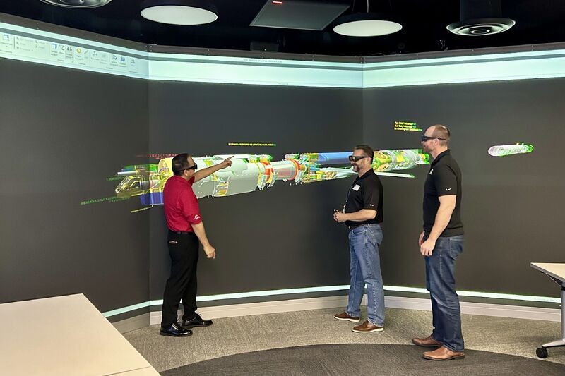 Community college professors showing students a 3D hardware model.