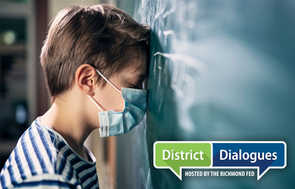 child leaning head on chalkboard 