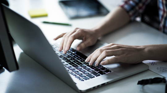 picture of woman typing on laptop