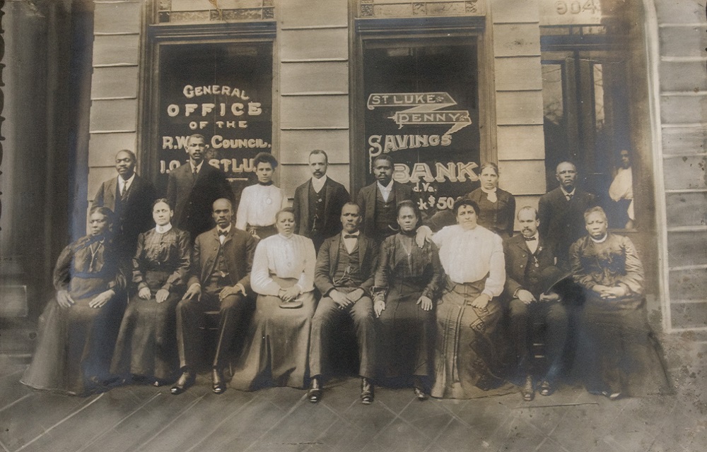 Photo of Maggie Walker (seated third from right) and staff outside of the St. Luke Penny Savings Bank