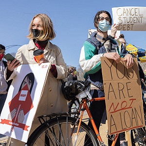 Group of people holding signs and protesting against student loans.