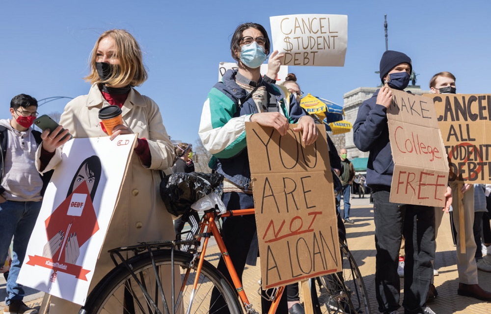 Group of people holding signs and protesting against student loans.