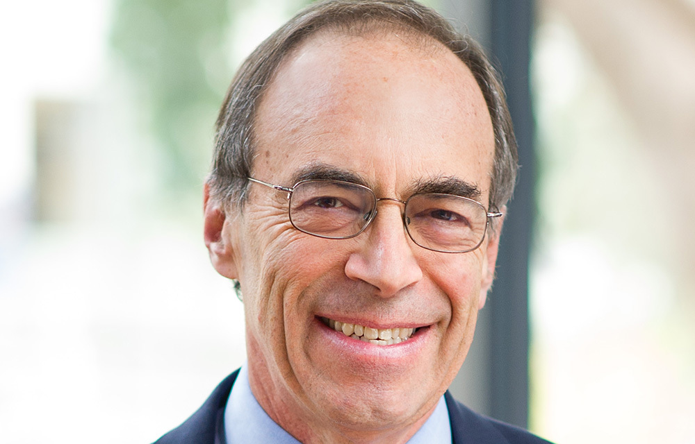Headshot photo of Alan Auerbach smiling.
