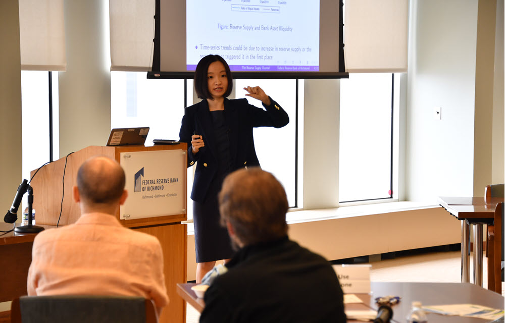 Yiming Ma presenting the paper “Monetary Policy Transmission in Segmented Markets”