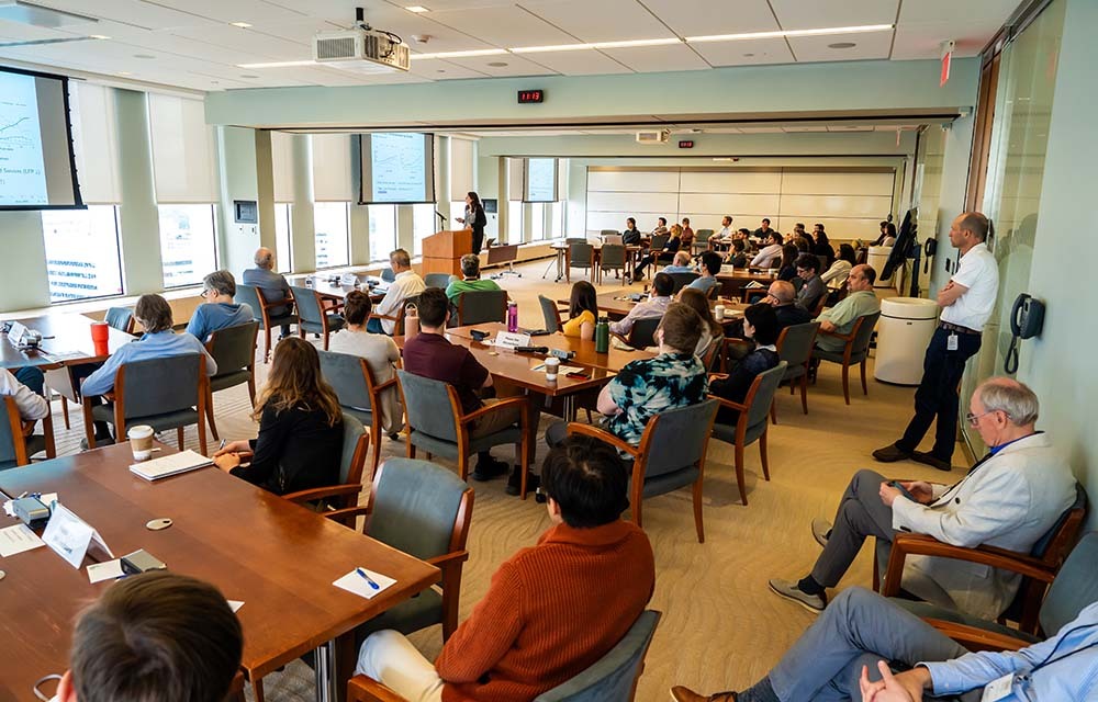 Large room of economists listening to a presentation at CORE Week.