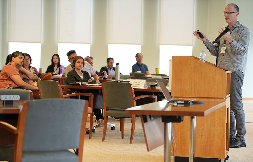 Presenter standing behind a podium and giving a presentation at CORE Week.