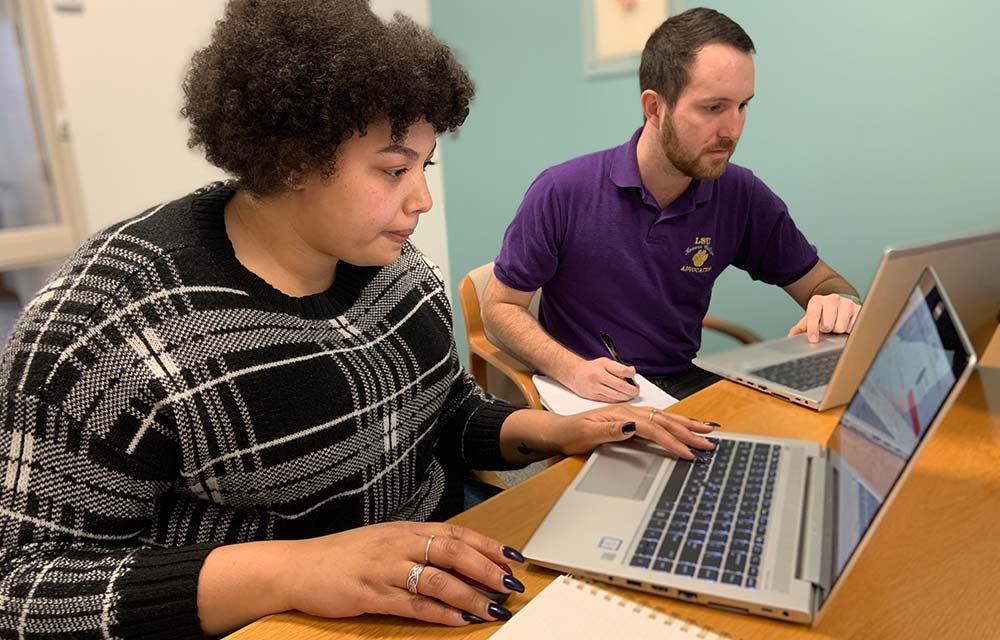 two people on their computers applying for jobs