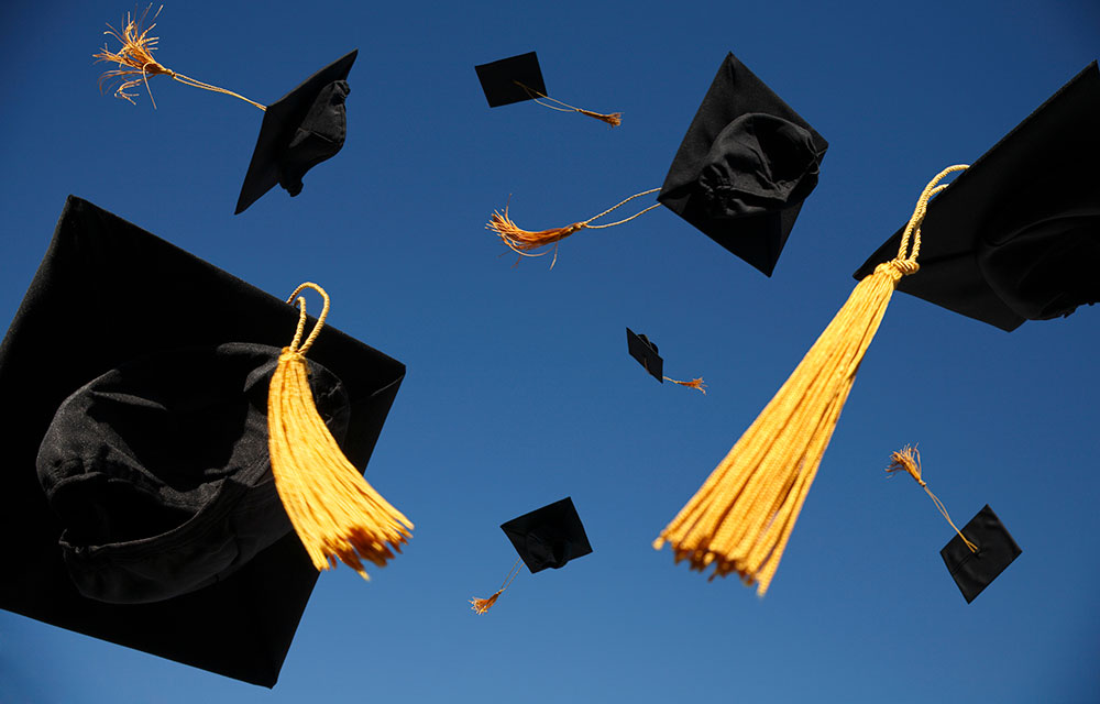 graduation caps thrown in the air