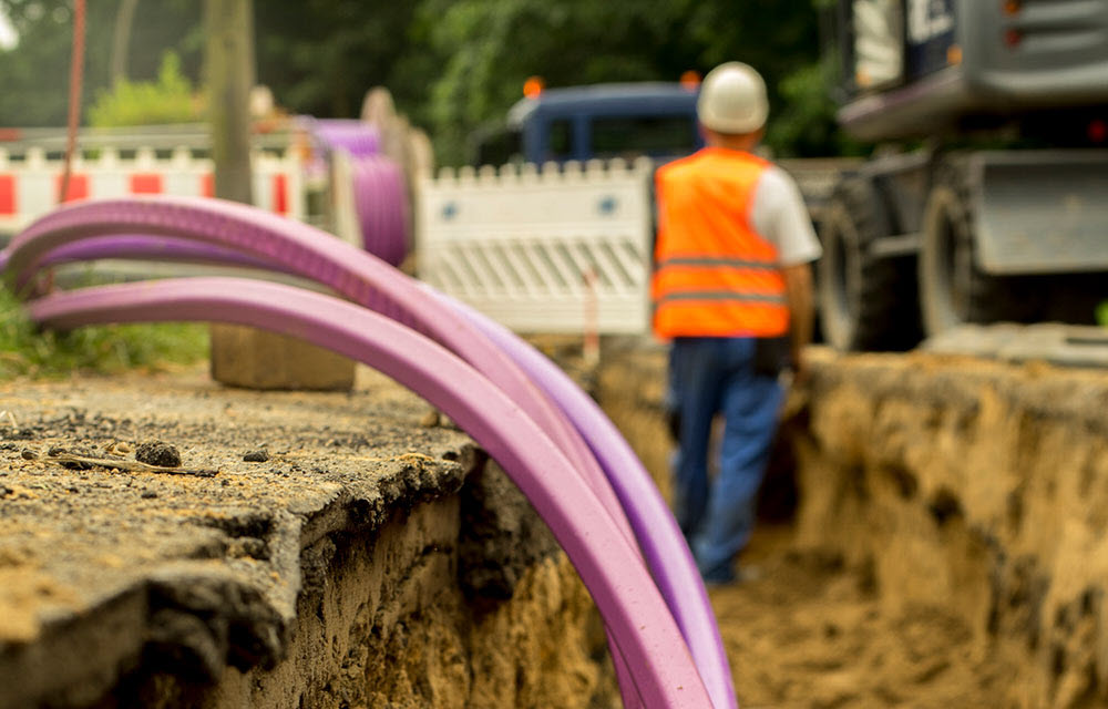 Worker readying cable to be buried