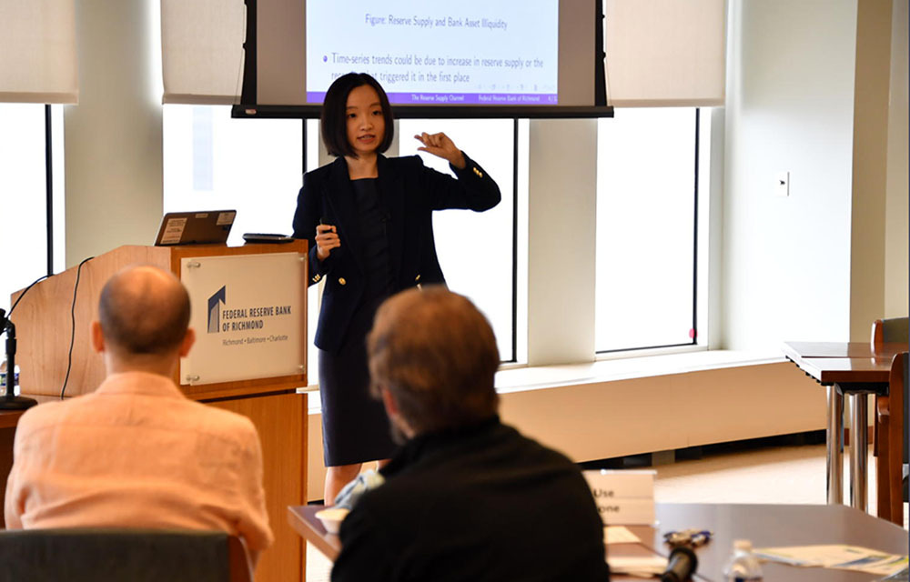 Yiming Ma presents her paper to attendees of the  Intermediation and Bank Liquidity Conference, part of August's CORE Week collaboration