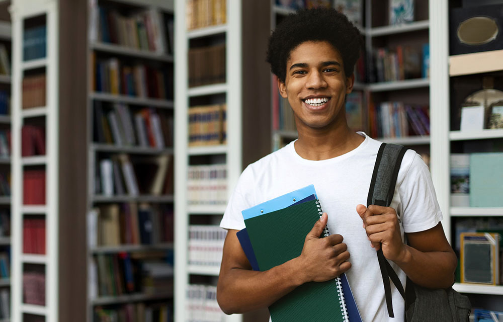 student with backpack in the library 