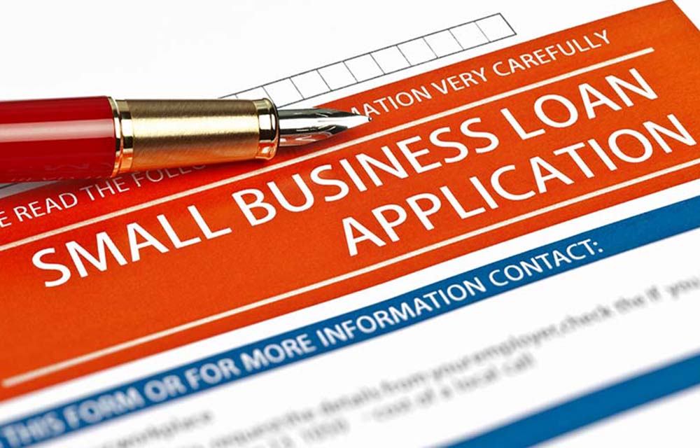 pen at the top of a form for a small business loan application