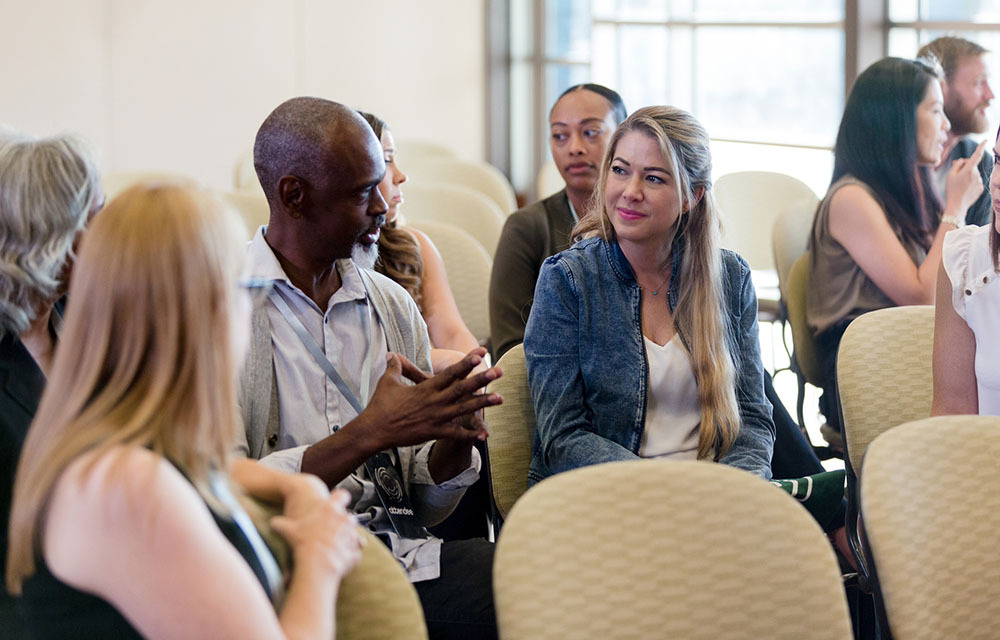 seated conference attendees in a discussion