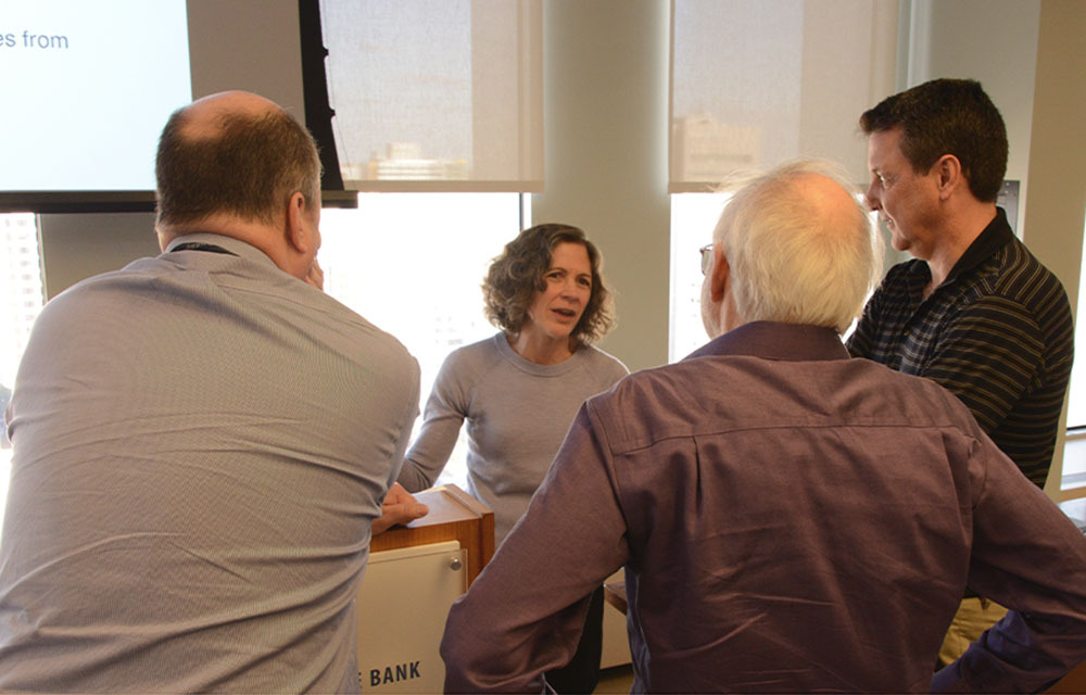 People standing in a room discussing at Core Week