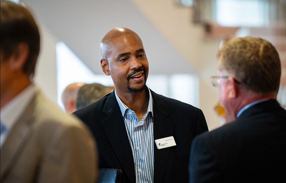 Brent Hassell talking with bankers