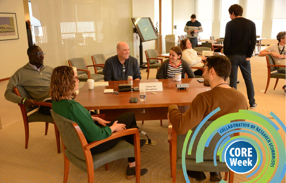 scene of economists around a table collaborating branded for CORE Week events