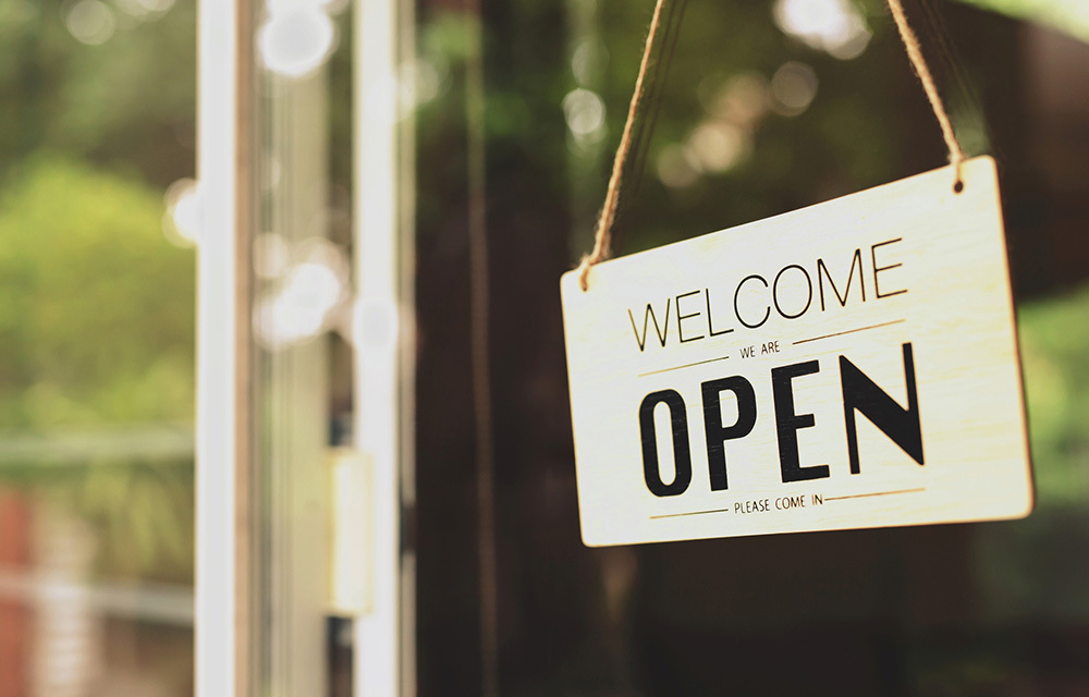 Window of a business with an open sign