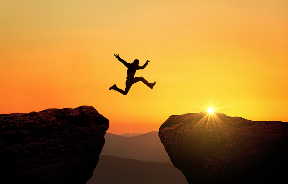 a person jumping a cliff