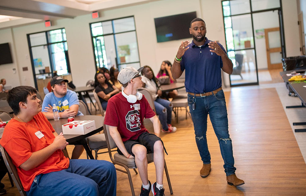 Steven DK Brown presenting to a class of kids interested in STEM.