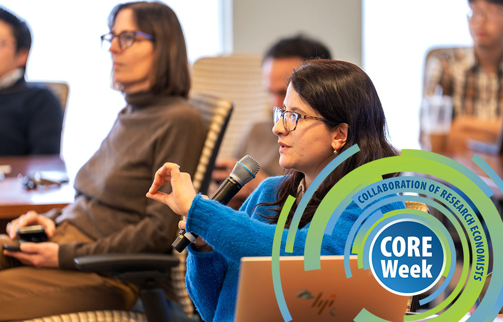 Audience member holding a microphone and asking the presenter a question during CORE Week.