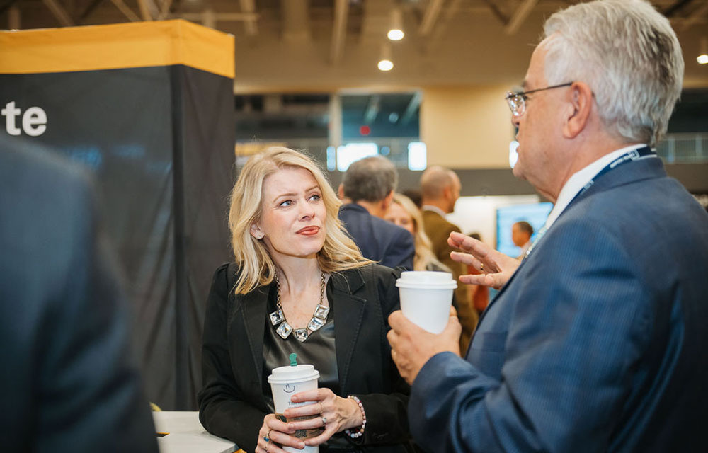 Renee Haltom chatting with a local business leader over coffee.