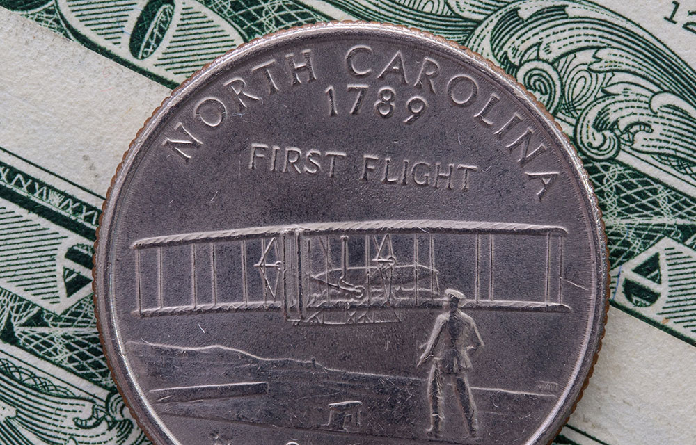 the back of a North Carolina quarter on a dollar bill