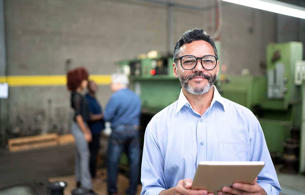 man with clipboard at a manufacturing shop