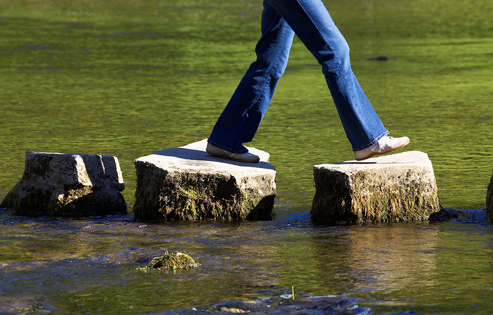 walking on stepping stones across water