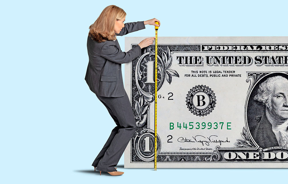 Woman measuring the height of a really big dollar bill with a tape measure