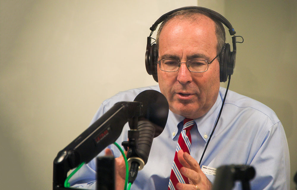 Tob Barkin behind the microphone in podcast studio