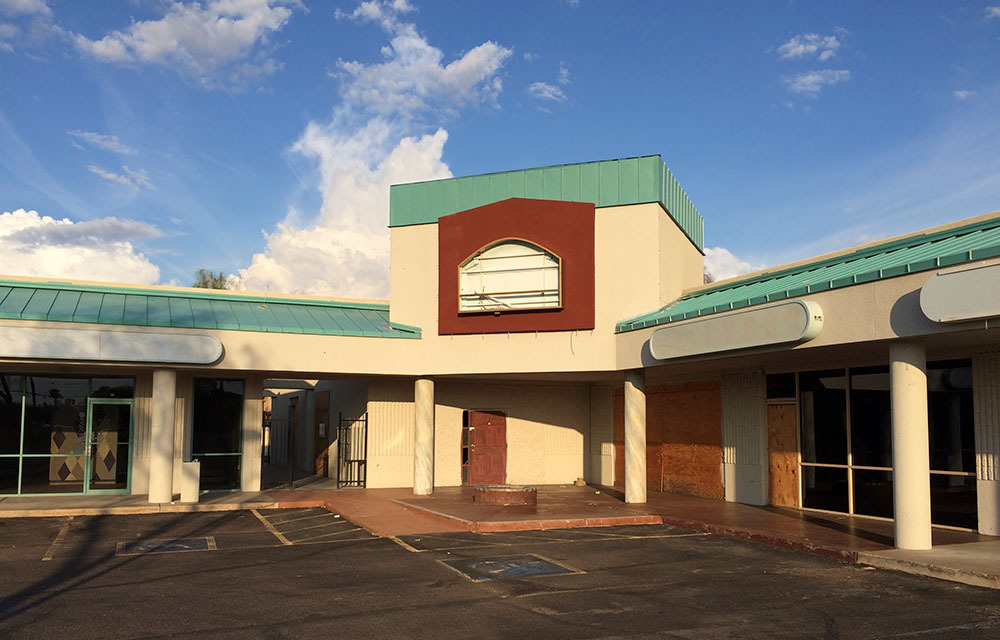 Empty, boarded-up shopping center