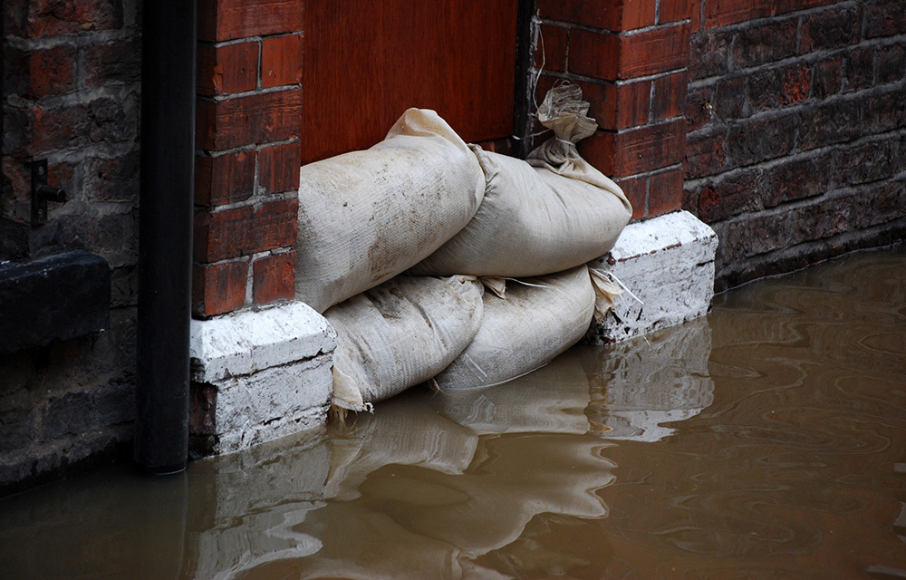 sandbags keeping back the floodwater from going through a door
