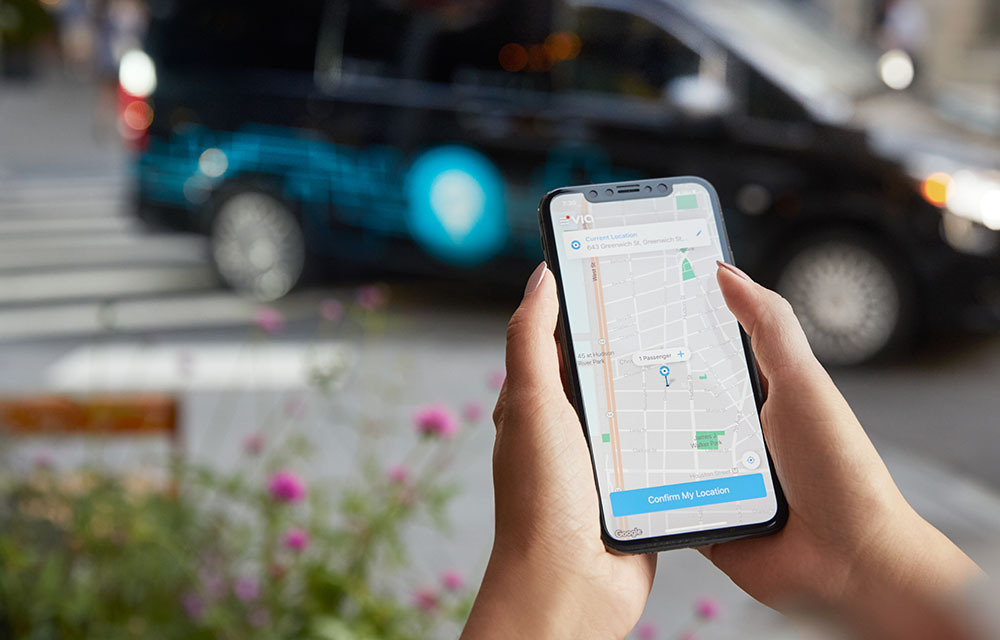 Using a mobile app to request a microtransit ride.