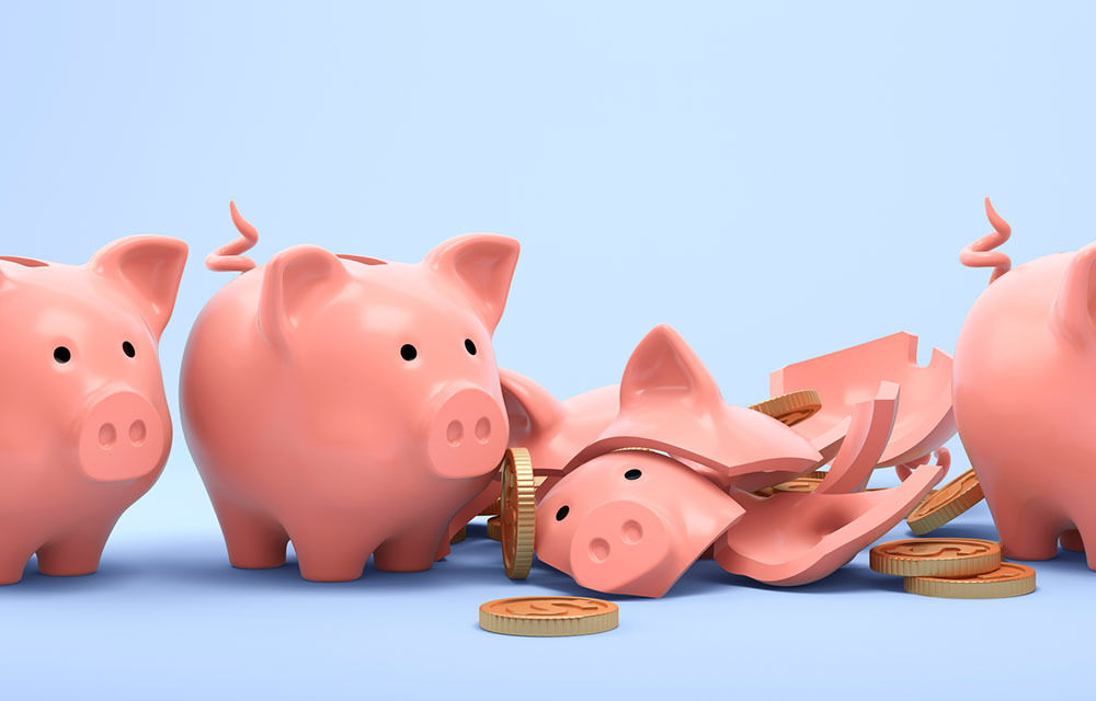 A line of pink piggy banks, with one piggy busted open