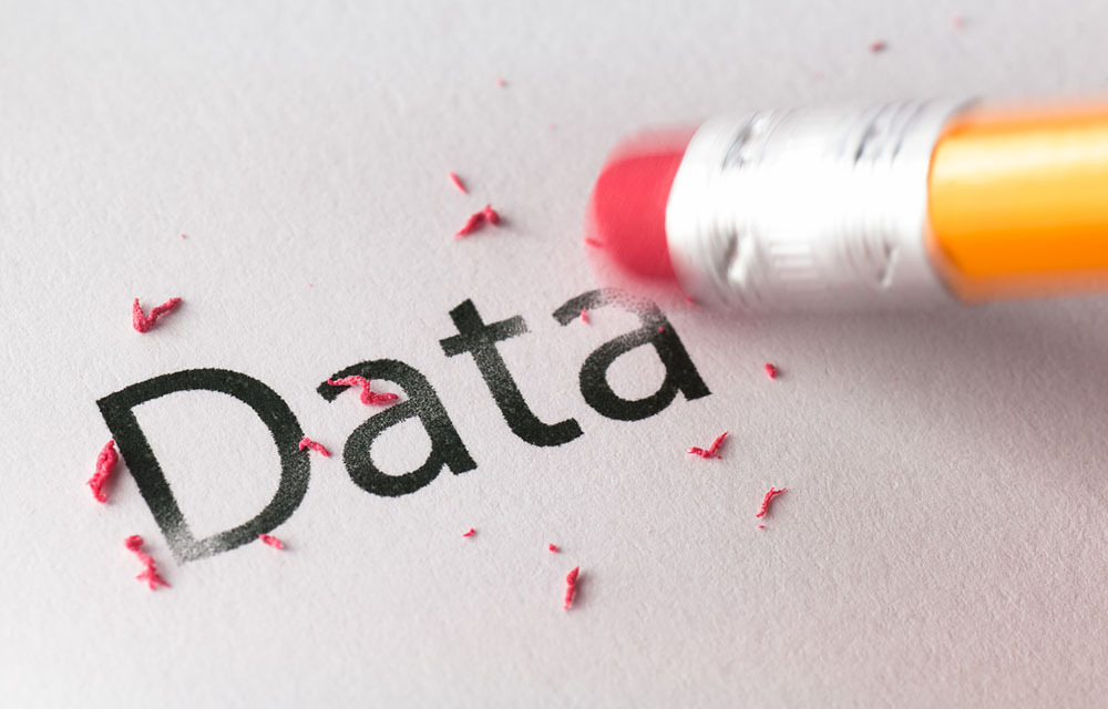 pencil erasing the word "data" from a piece of paper