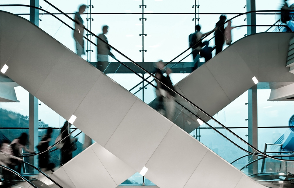 People going up and down escalators