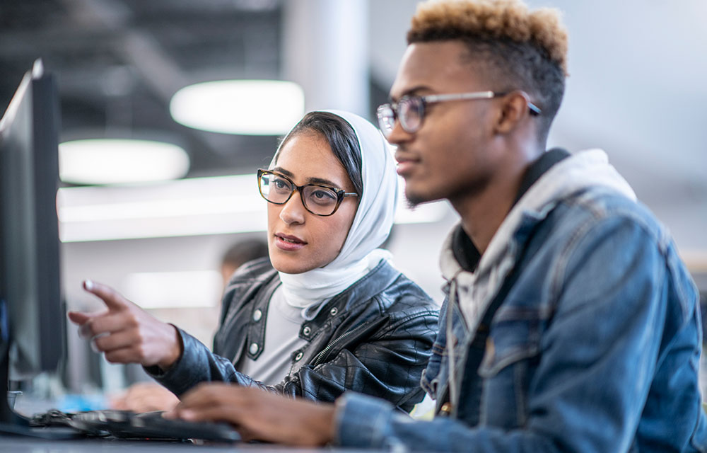 two people looking at a screen