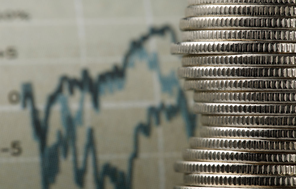 coins stacked up in front of a chart