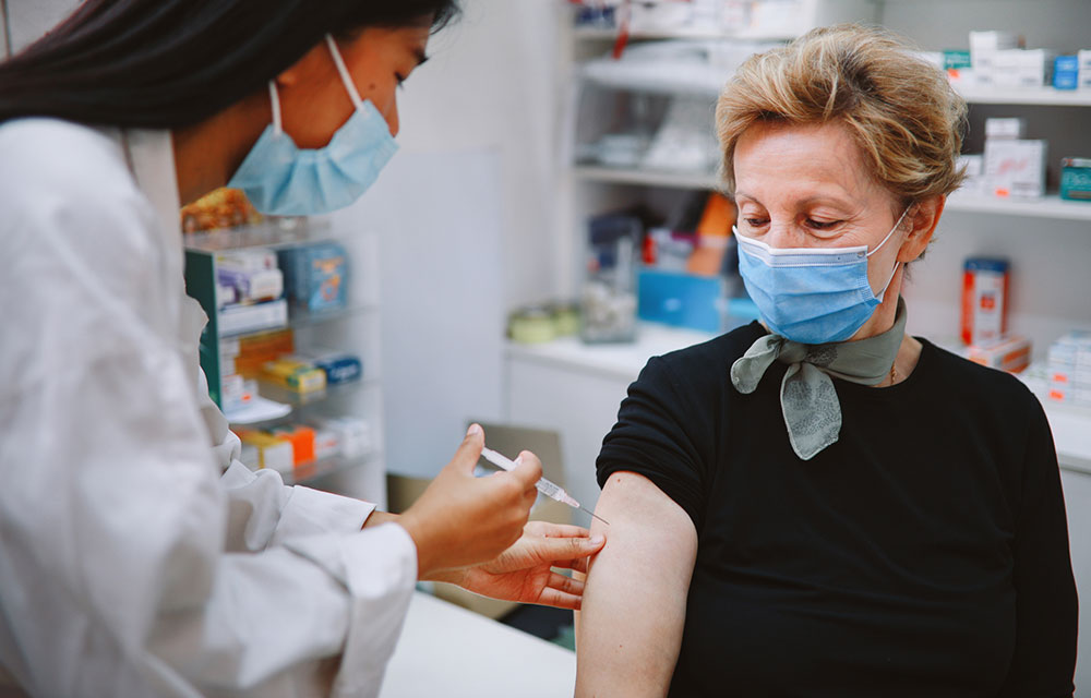 person receiving a vaccination shot from a health care provider