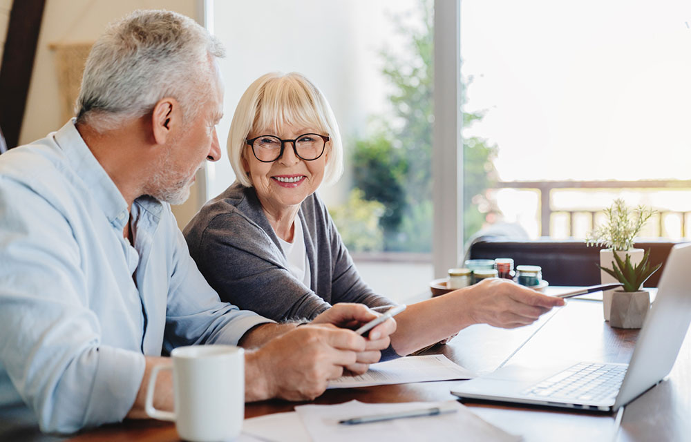 two elders chatting with coffee at the computer