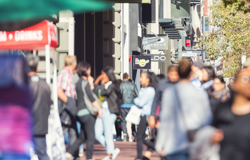 image depicting stores located on a busy street