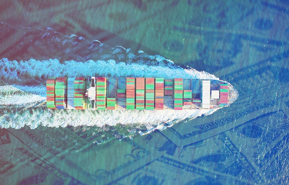 Aerial view of a large container cargo ship sailing on a sea of money.