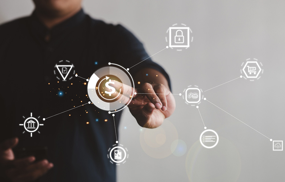 A person pushing a digital money icon that is webbed out to various other icons to show they are connected.