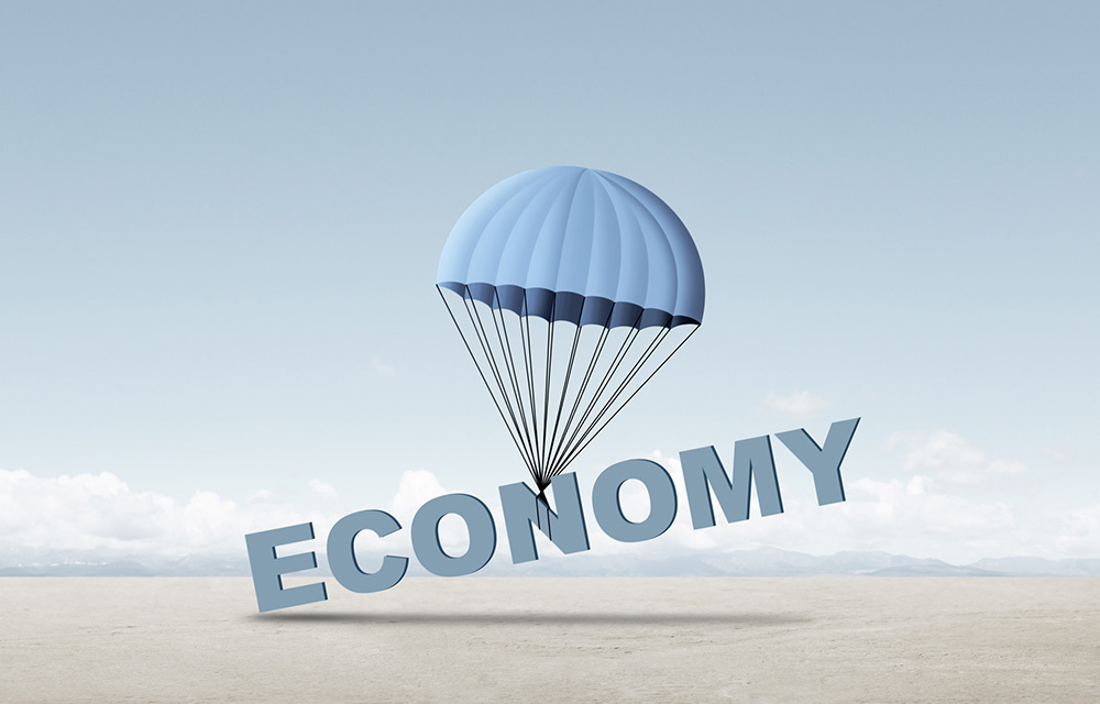 Blue parachute attached to the word "economy", slowly lowering to ground below.