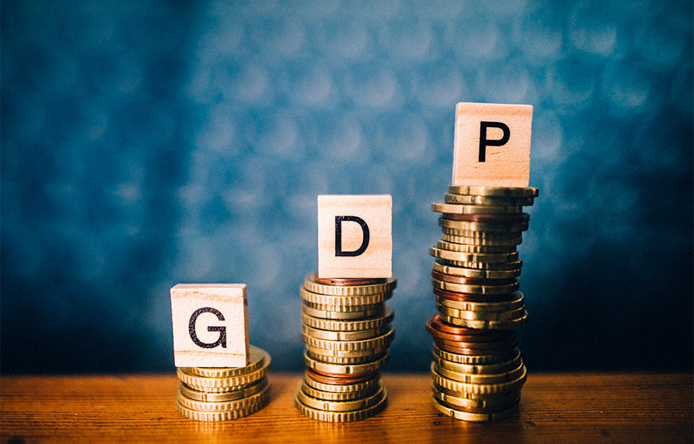 Three stacks of coins with a letter block on top that spell out "g" "d" "p."