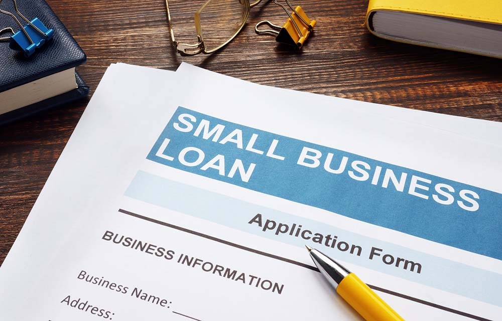 Close up on a small business loan application form with a pen laying on top.