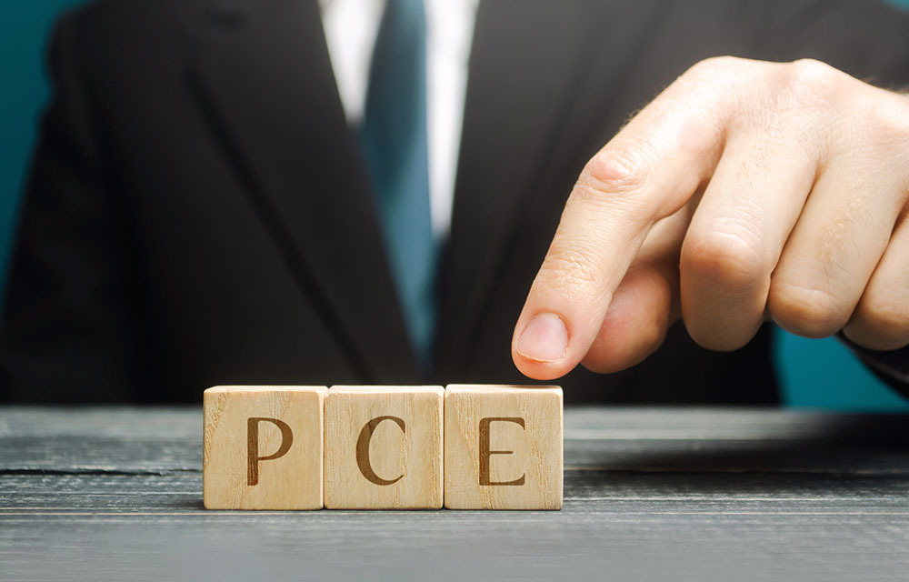 Row of wooden blocks with the individual letters of "PCE" spelled.